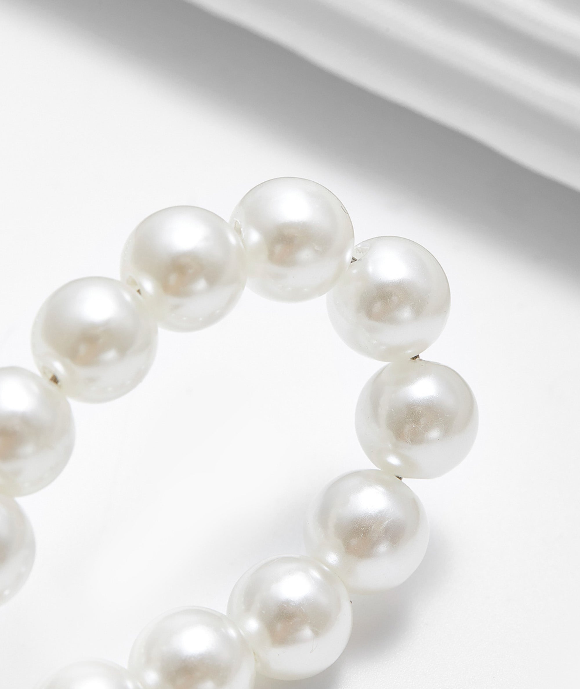 Arcadie matelassé nappa leather bag charm, pearl decorative accessory, bow-shaped keychain.